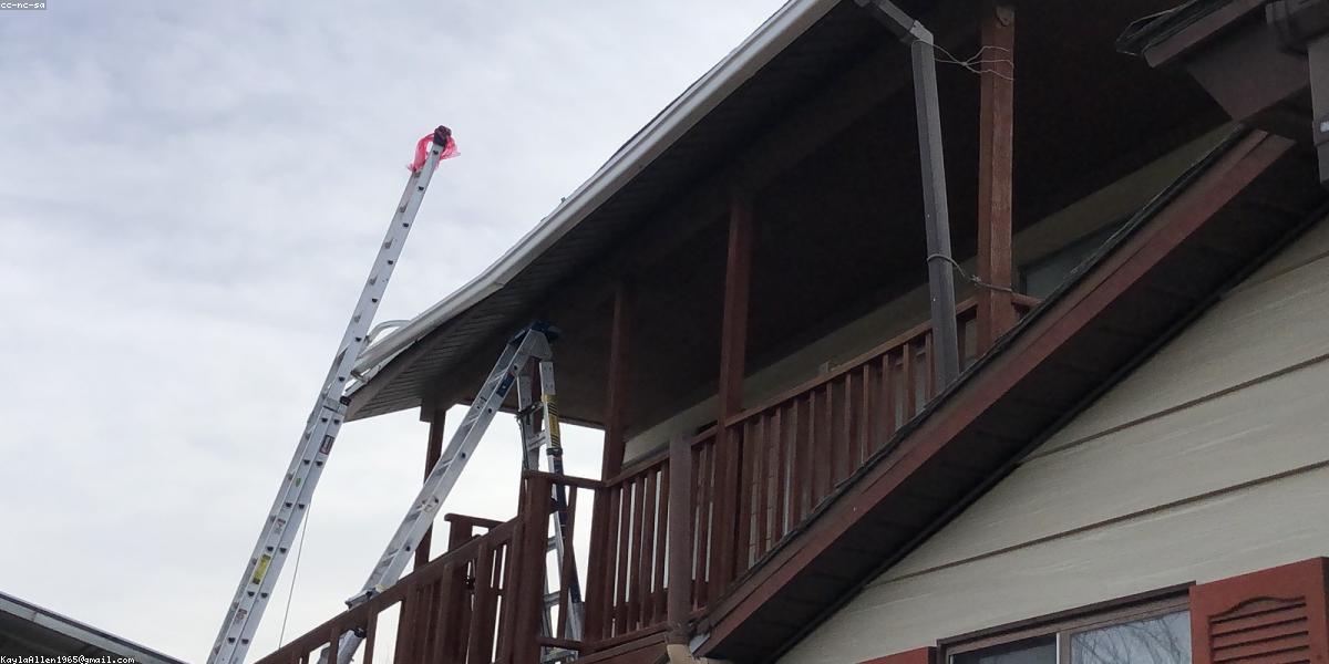 Crew installing gutter guards